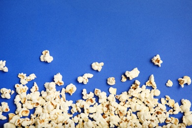 Tasty fresh popcorn on color background, top view