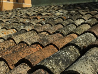 Photo of Surface of old tiled house roof, closeup