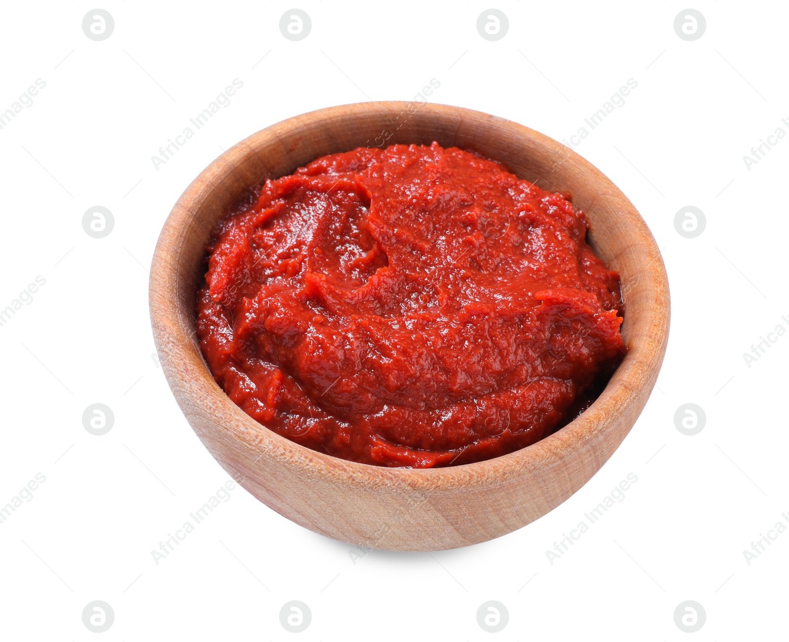 Photo of Wooden bowl of tasty tomato paste isolated on white