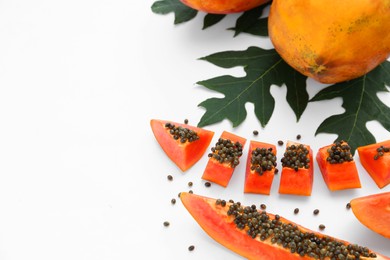 Fresh ripe cut and whole papaya fruits with leaf on white background. Space for text