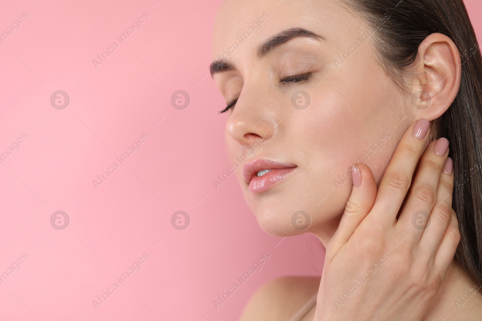 Photo of Beautiful young woman with healthy skin on pink background, closeup. Space for text