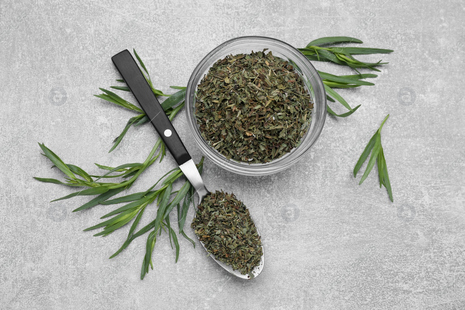Photo of Dry and fresh tarragon on light gray textured table, flat lay