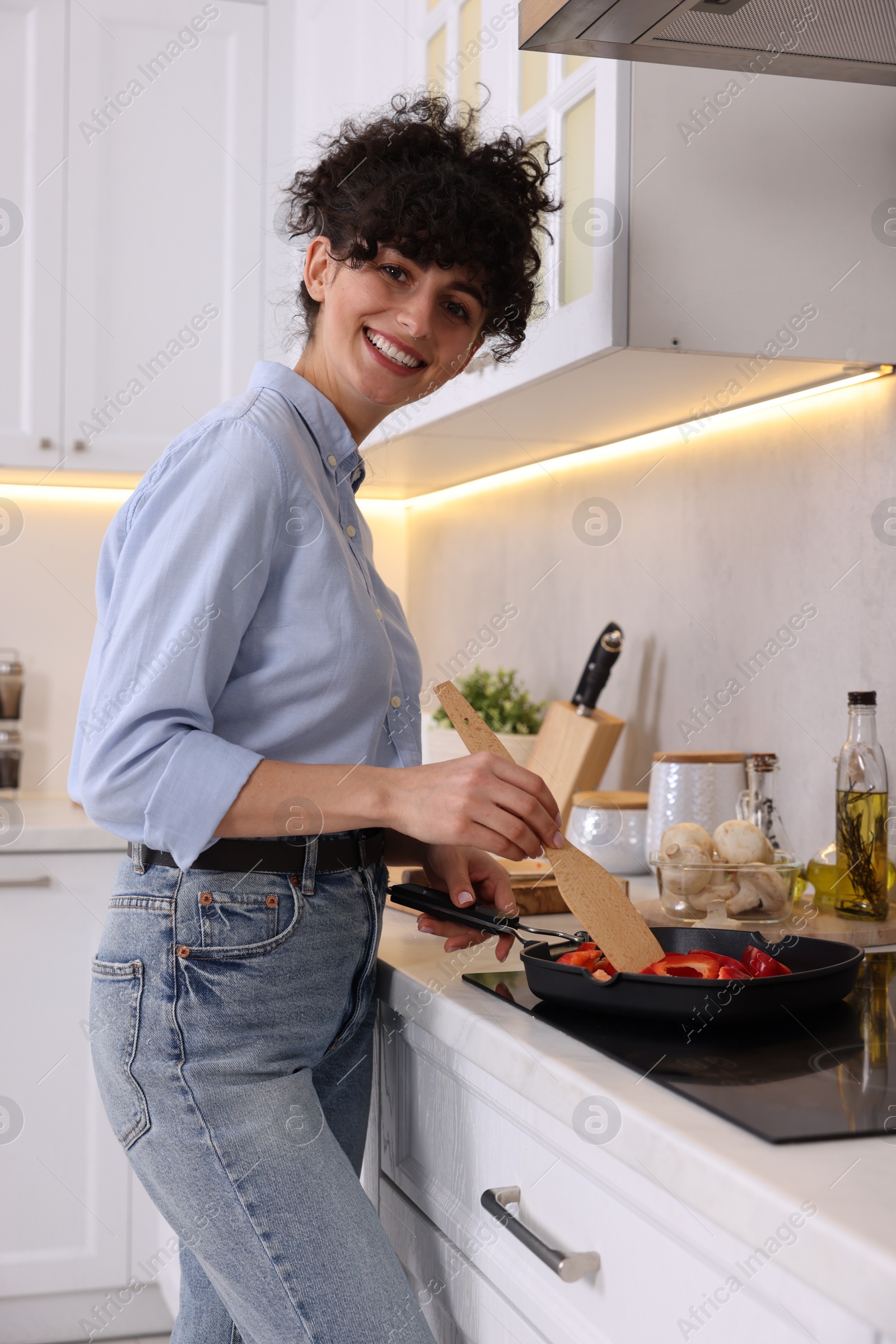 Photo of Smiling food blogger cooking in kitchen at home