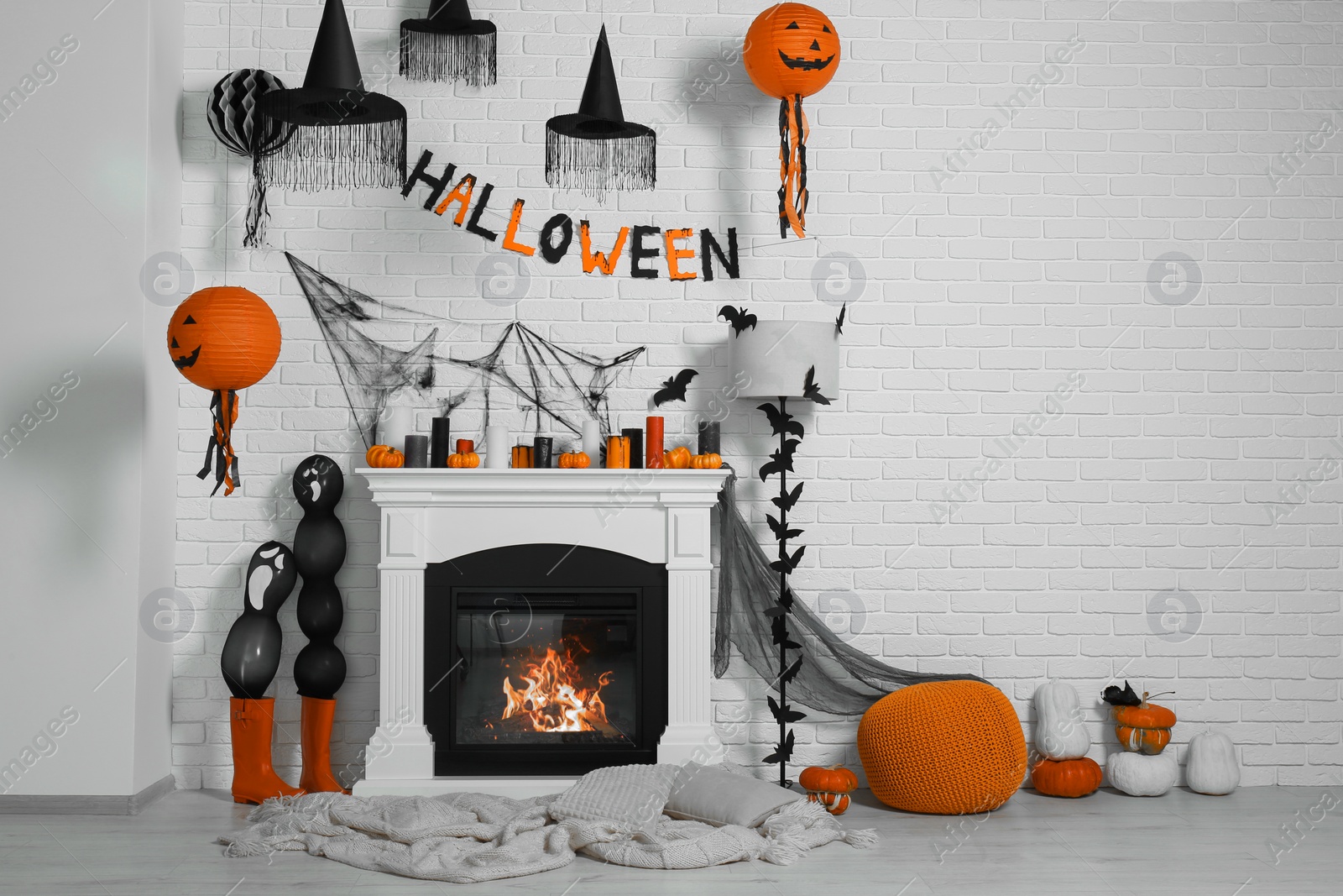 Photo of Room with fireplace decorated for Halloween. Festive interior