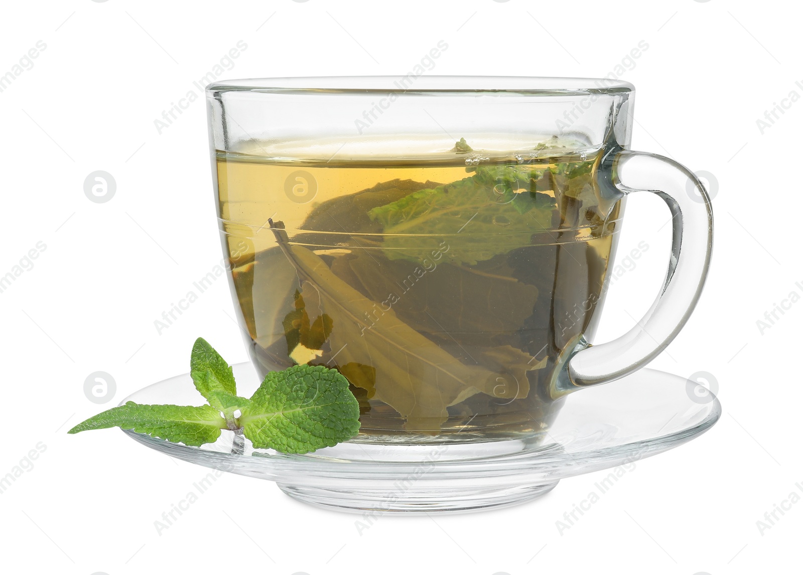 Photo of Fresh green tea in glass cup, mint and saucer isolated on white