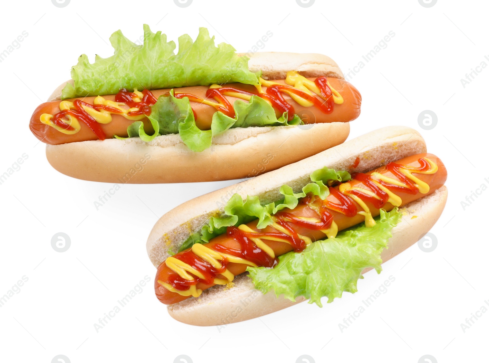 Photo of Tasty hot dogs with lettuce, ketchup and mustard isolated on white, top view