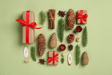 Flat lay composition with pinecones on green background