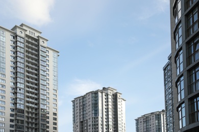 Modern buildings with tinted windows against sky. Urban architecture