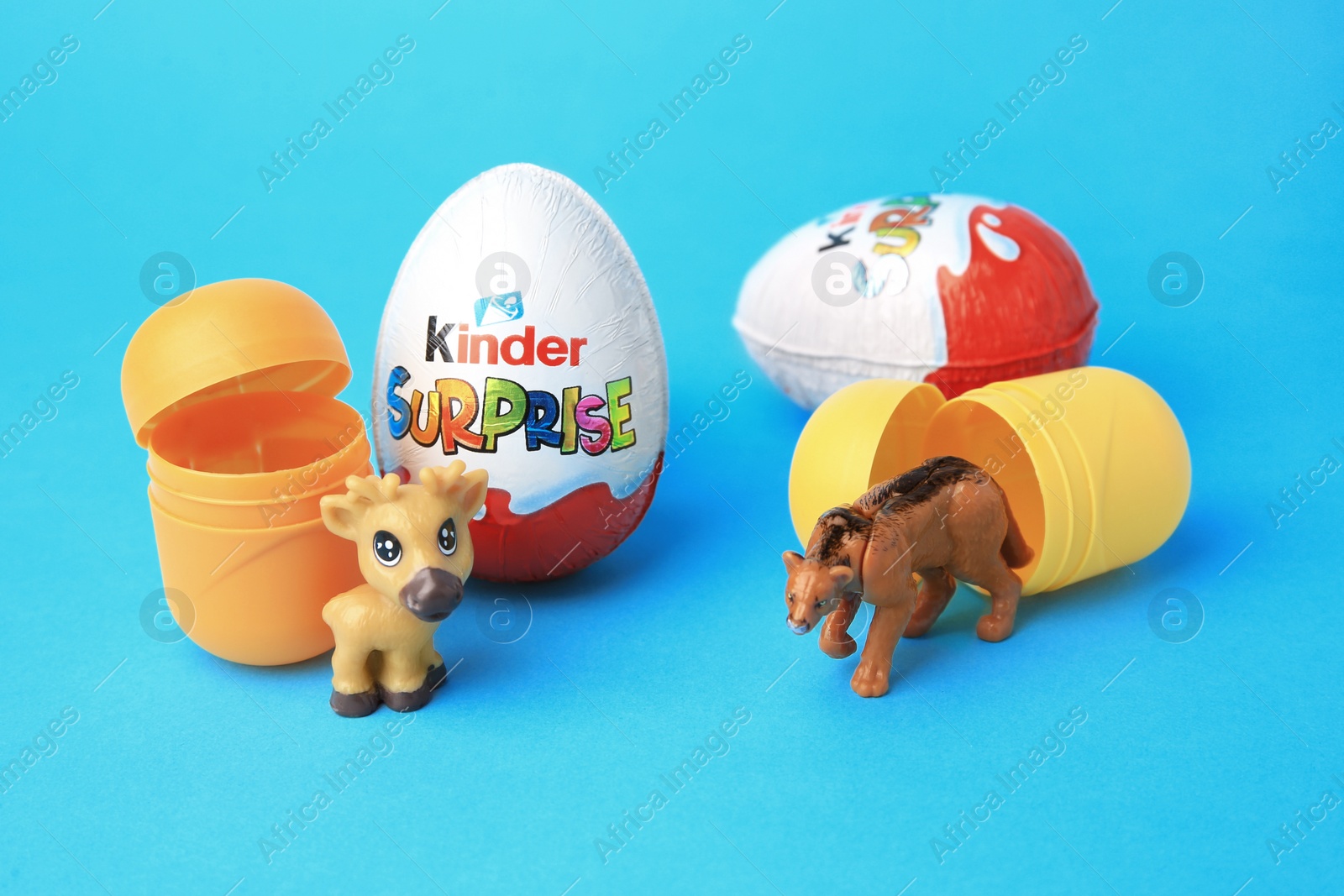 Photo of Slynchev Bryag, Bulgaria - May 25, 2023: Kinder Surprise Eggs, plastic capsules and toys on light blue background