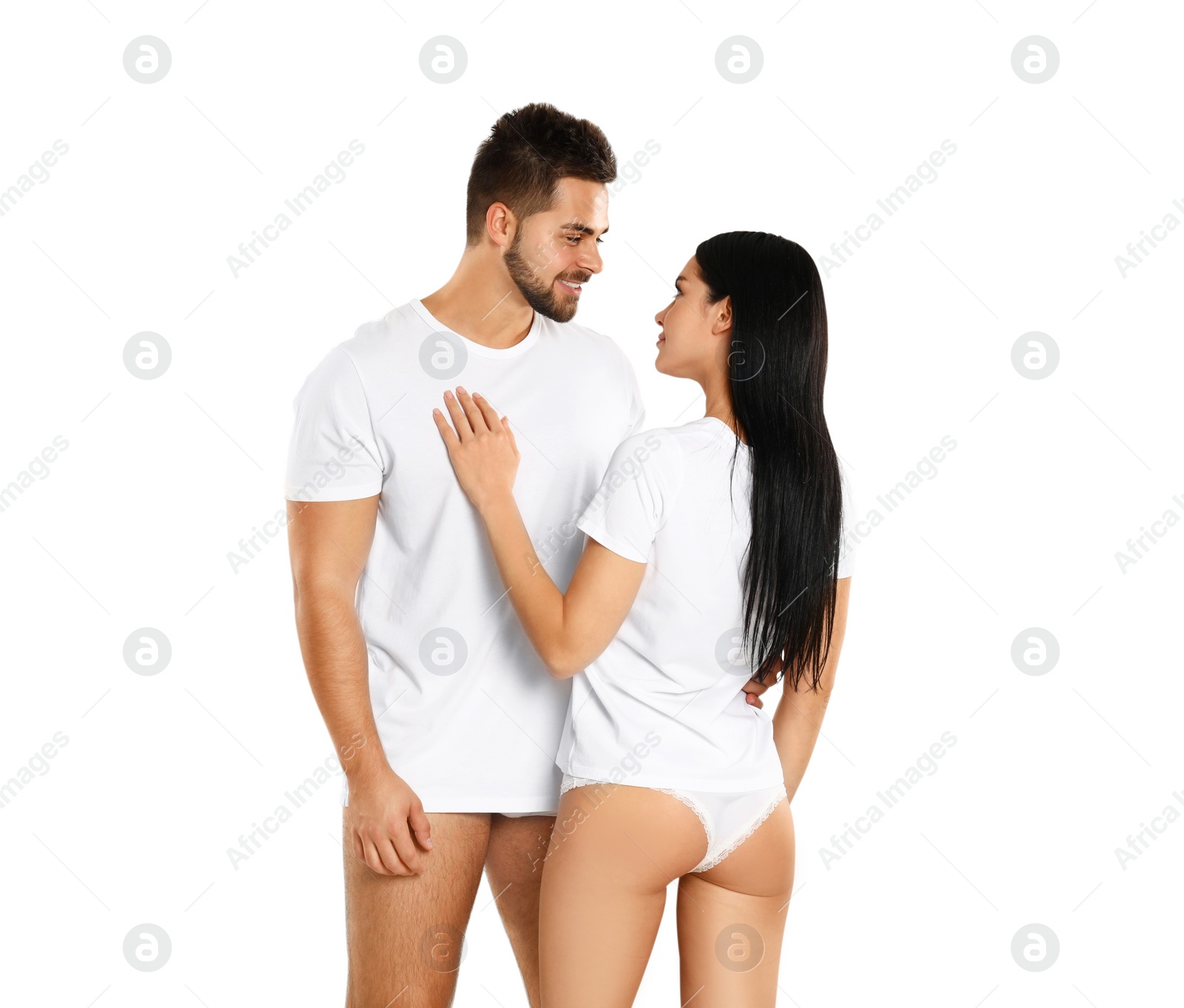 Photo of Young couple in white t-shirts and underwear on light background