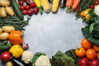 Photo of Frame of fresh ripe vegetables on grey table, flat lay. Space for text