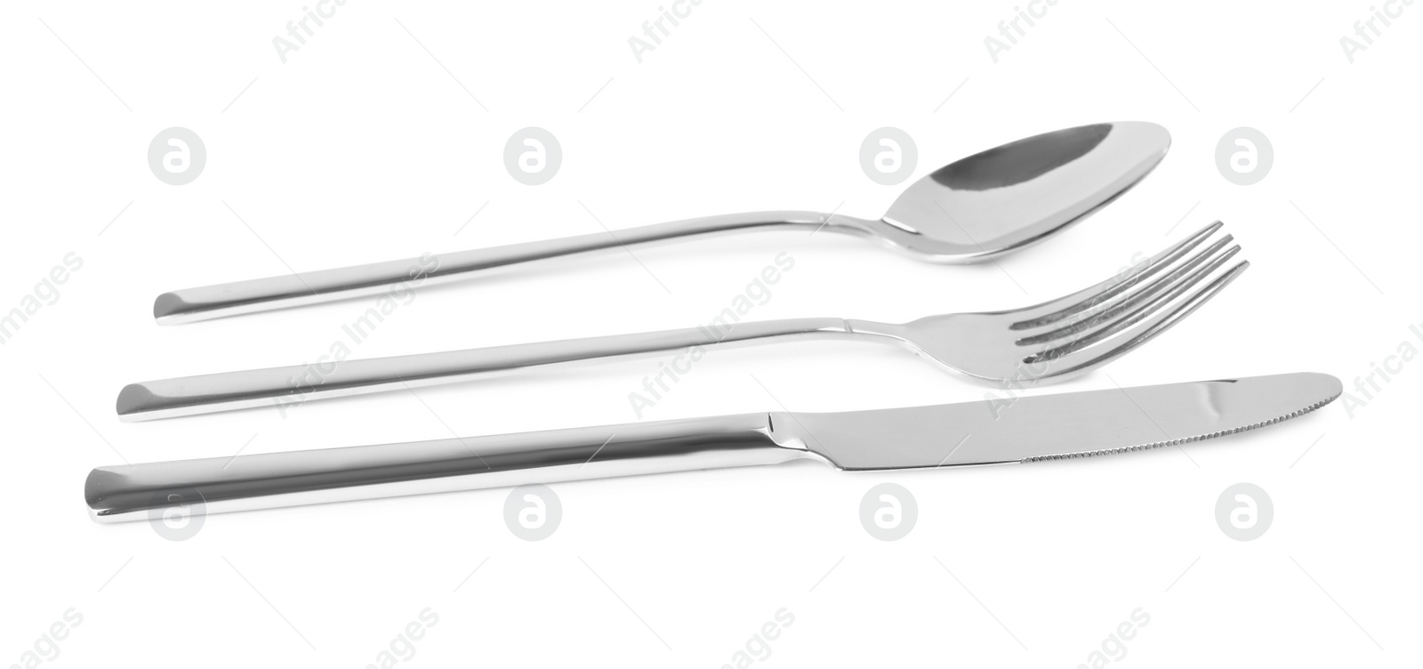 Photo of New shiny fork and knife on white background