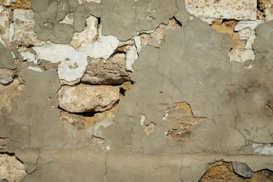 Stone building wall with cracks after strong earthquake