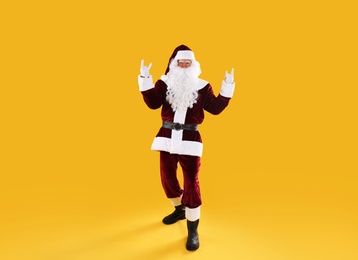 Full length portrait of Santa Claus on yellow background