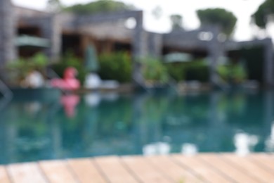 Blurred view of outdoor swimming pool at luxury resort