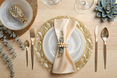 Elegant table setting on wooden background, top view