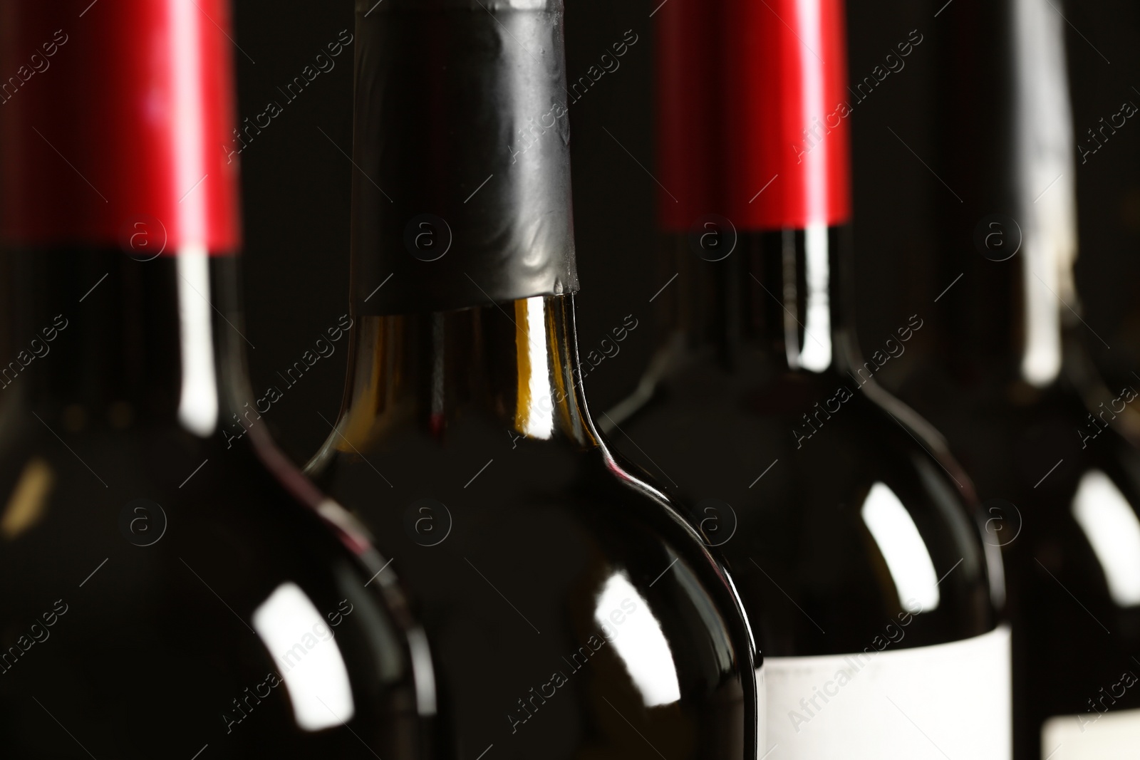 Photo of Bottles of different wines, closeup. Expensive collection