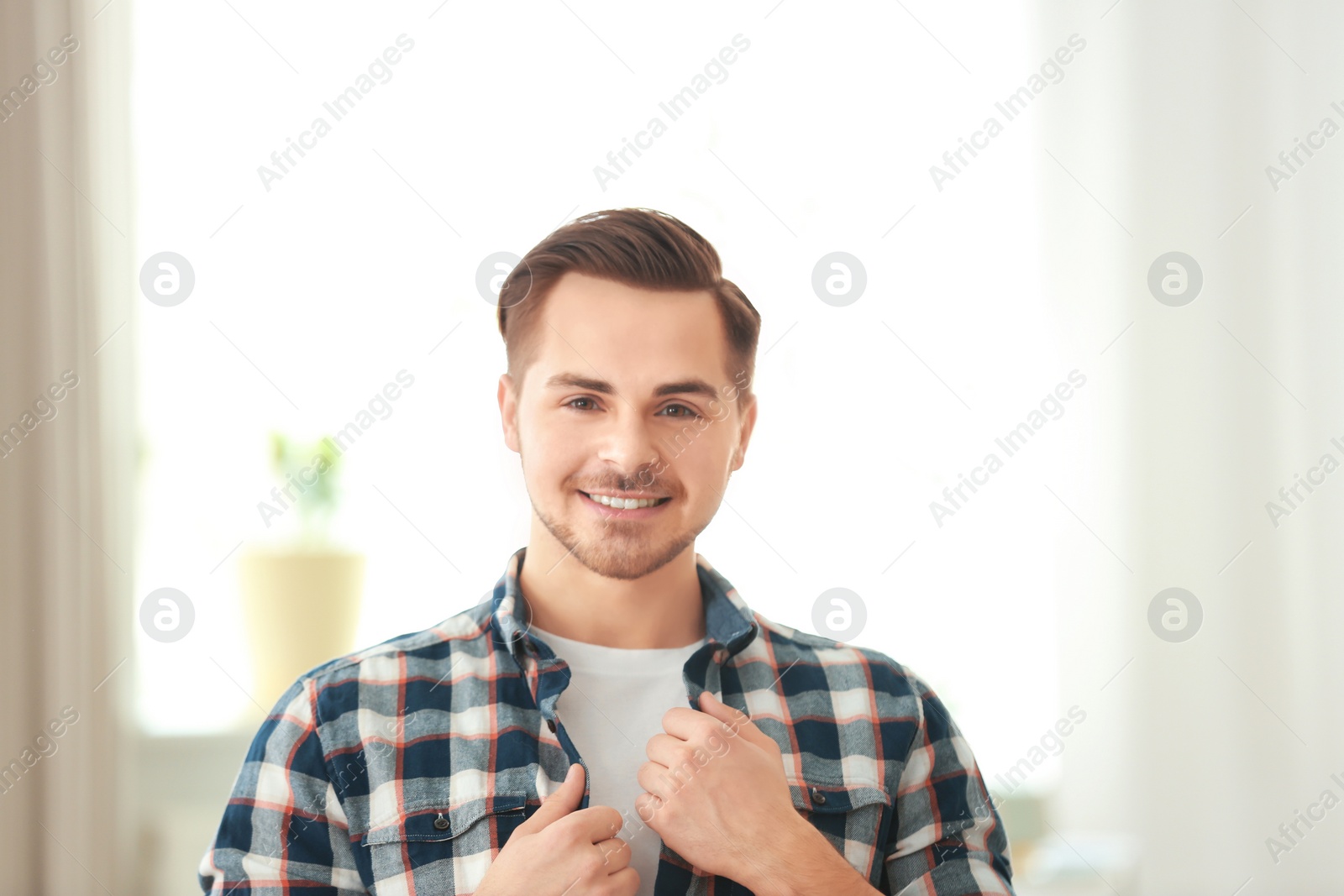 Photo of Portrait of young man with beautiful hair indoors