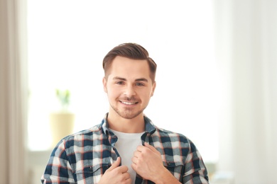 Photo of Portrait of young man with beautiful hair indoors