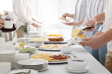 People taking food during breakfast, closeup. Buffet service