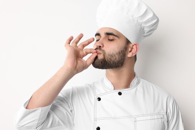 Photo of Professional chef showing perfect sign on white background