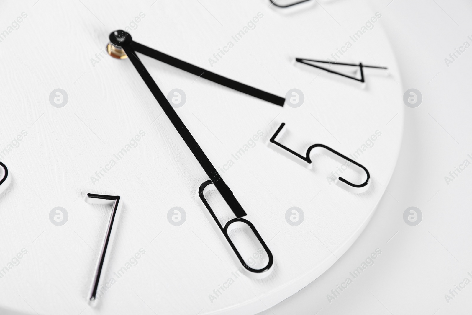 Photo of Stylish analog clock on white background, closeup