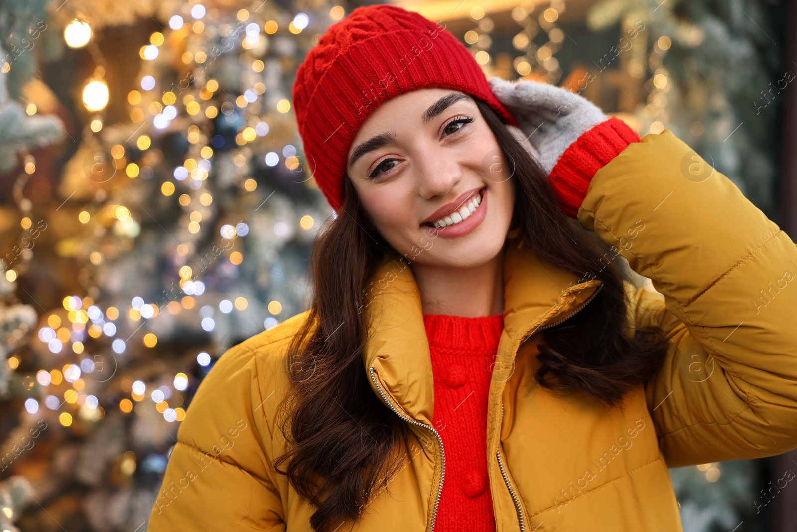 Photo of Portrait of smiling woman on blurred background. Winter time