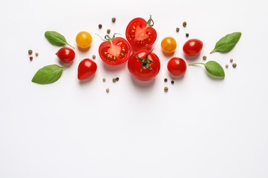 Photo of Composition with ripe cherry tomatoes and basil leaves on white background, top view