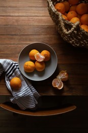 Photo of Fresh ripe tangerines on wooden table, flat lay