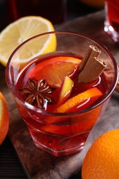 Photo of Glass of aromatic punch drink on table, closeup