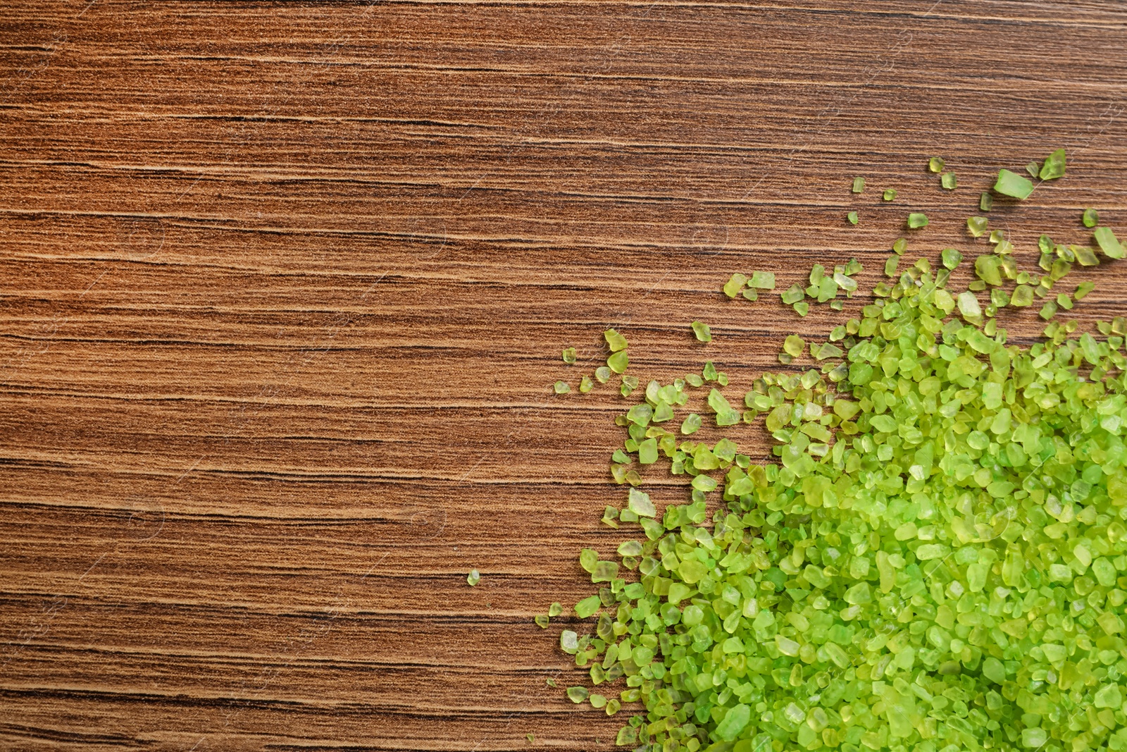 Photo of Aromatic sea salt on wooden table, top view. Space for text