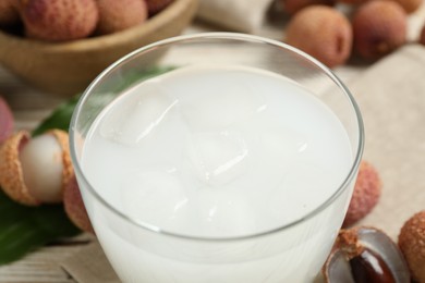Photo of Freshly made lychee juice on table, closeup