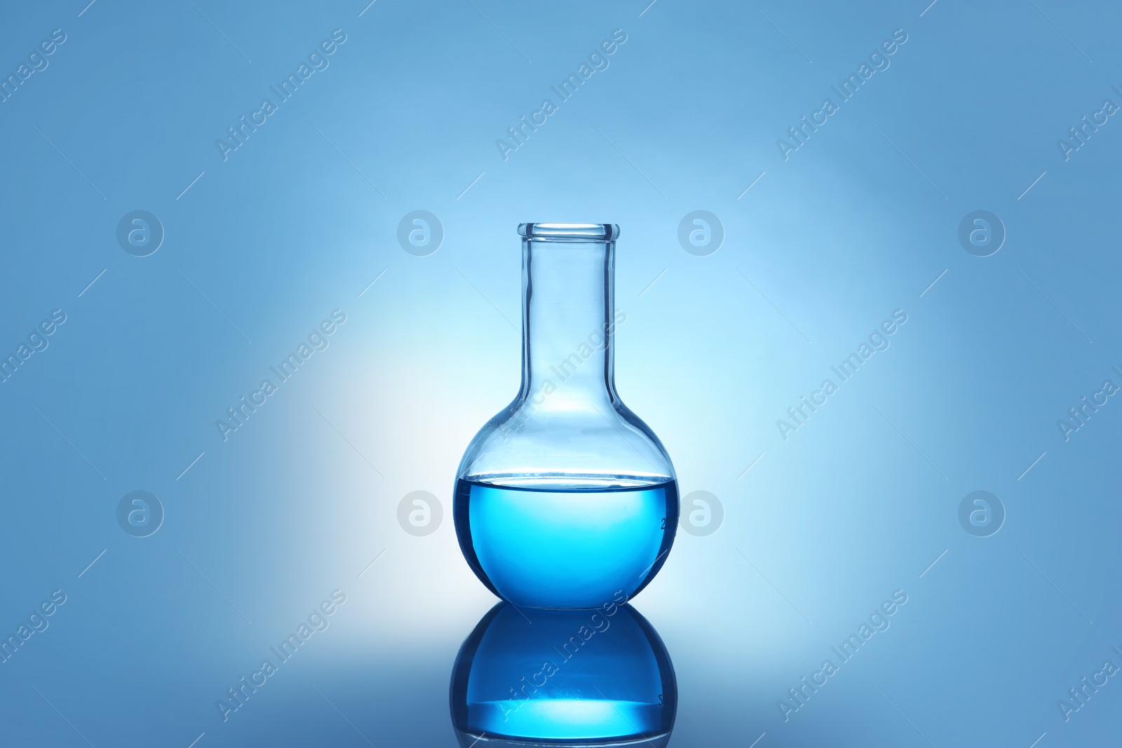 Photo of Flask with liquid on table against color background. Laboratory analysis