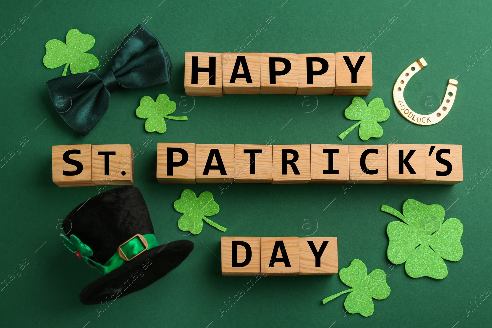 Photo of Words Happy St. Patrick's day and festive decor on green background, flat lay