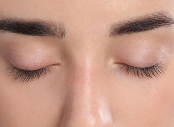 Photo of Young woman with beautiful natural eyelashes, closeup view