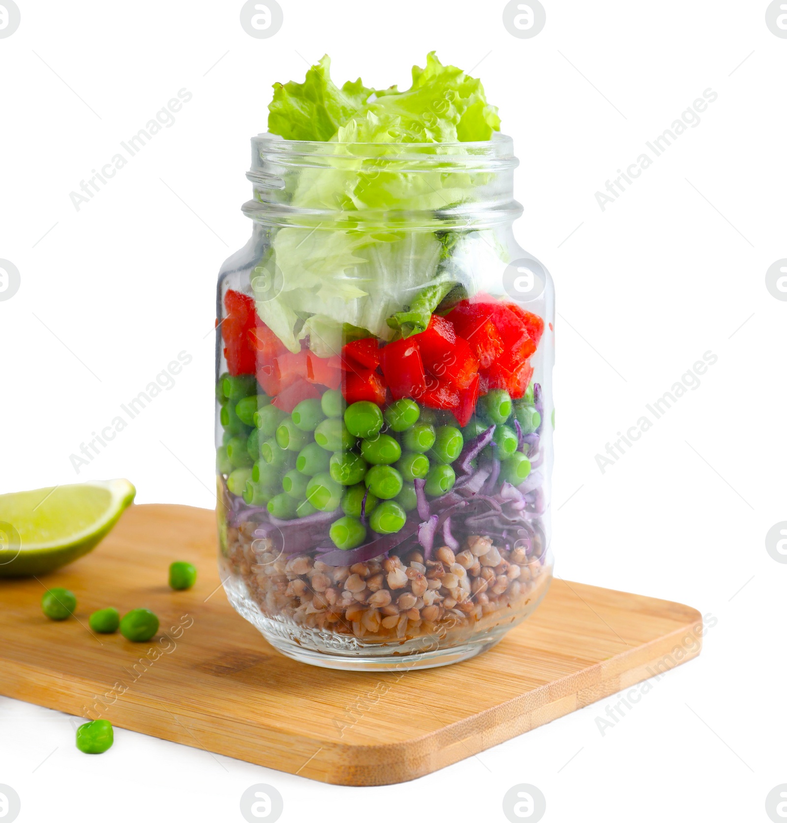 Photo of Healthy salad in glass jar on white wooden table. Space for text