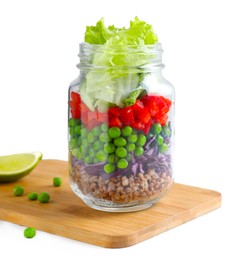 Photo of Healthy salad in glass jar on white wooden table. Space for text
