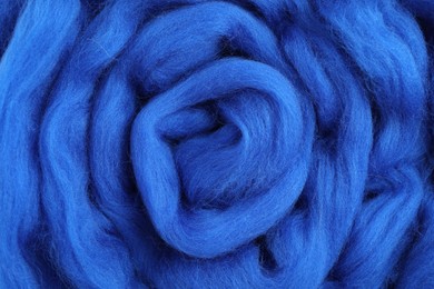 Blue felting wool as background, closeup view