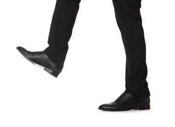 Photo of Businessman in leather shoes on white background, closeup