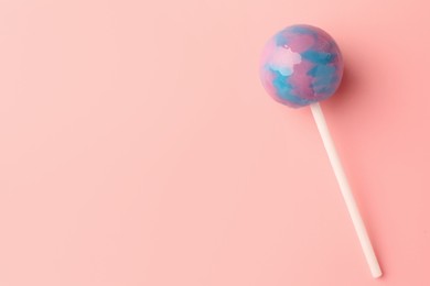 One tasty lollipop on pink background, top view. Space for text