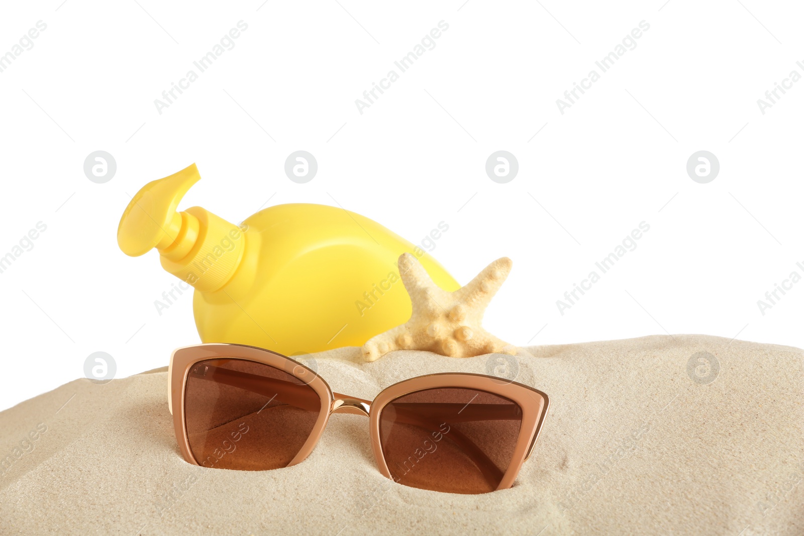 Photo of Beach accessories on sand against white background