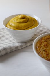 Photo of Bowl of whole grain mustard on white wooden table