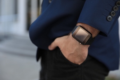 Photo of Man with smart watch outdoors, closeup view
