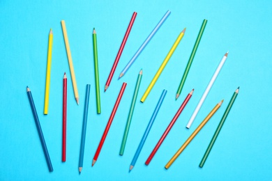 Photo of Colorful pencils on light blue background, flat lay