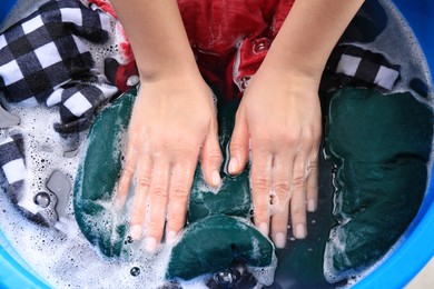 Woman washing garment in basin, closeup. Laundry