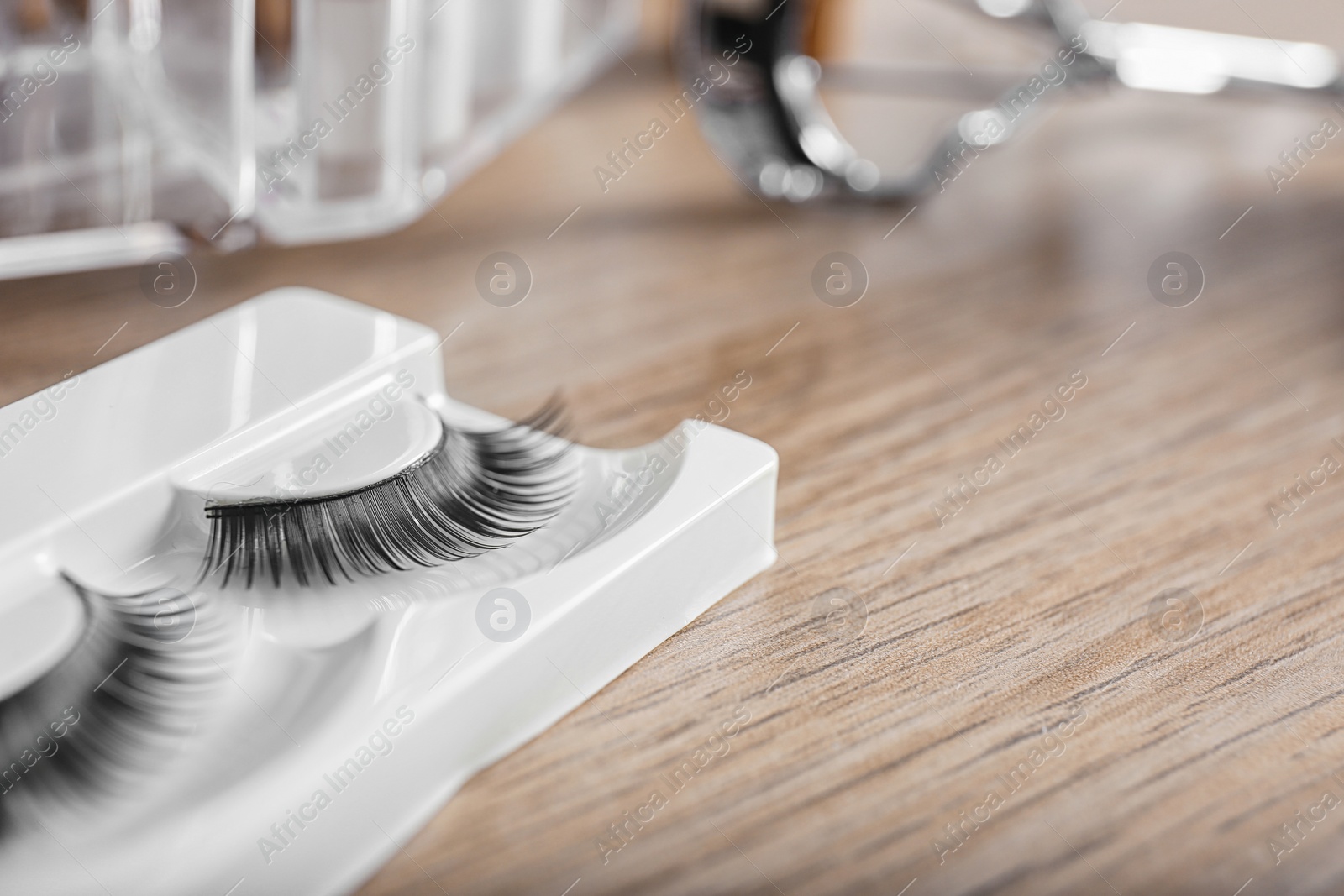 Photo of False eyelashes for makeup on table, closeup