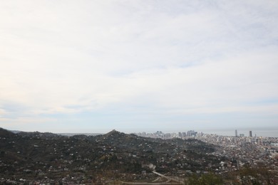 Picturesque view of city and sea under sky