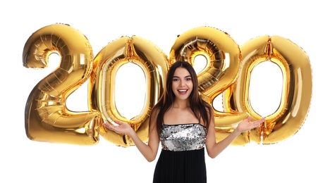 Photo of Happy young woman with golden 2020 balloons on white background. New Year celebration