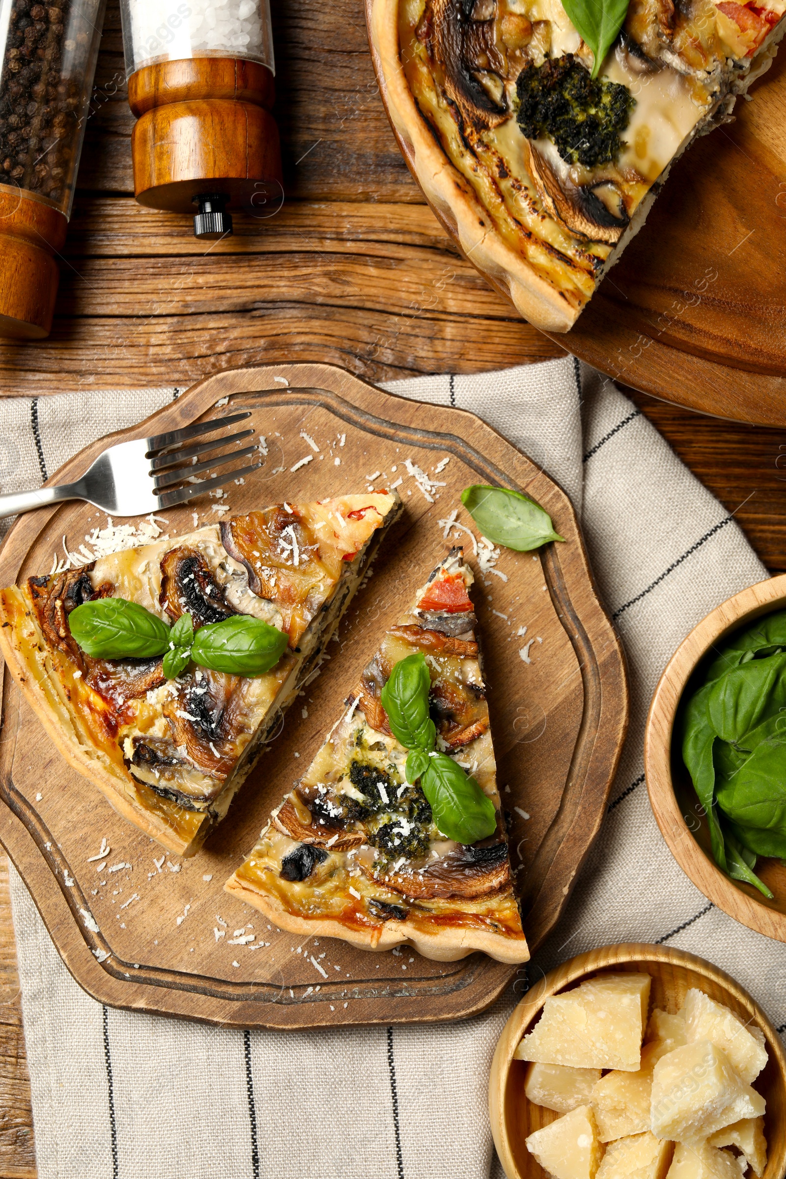 Photo of Delicious quiche with mushrooms and ingredients on wooden table, flat lay