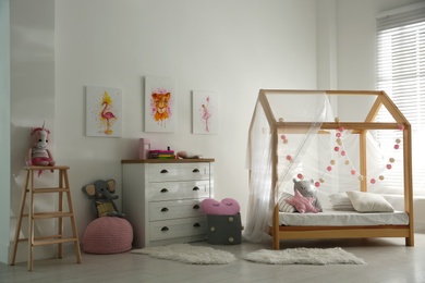 Photo of Cute pictures and and stylish furniture in baby room interior